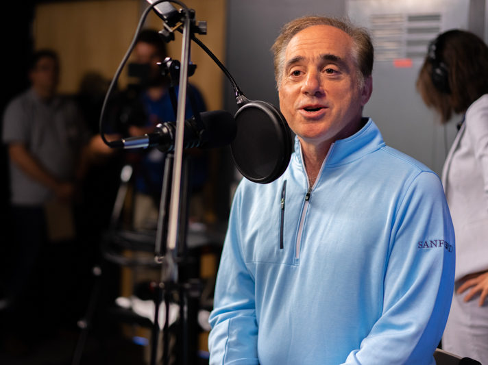 veterans health care: David Shulkin speaking into microphone in podcast studio