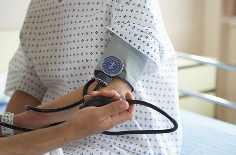 doctor taking blood pressure on person's arm