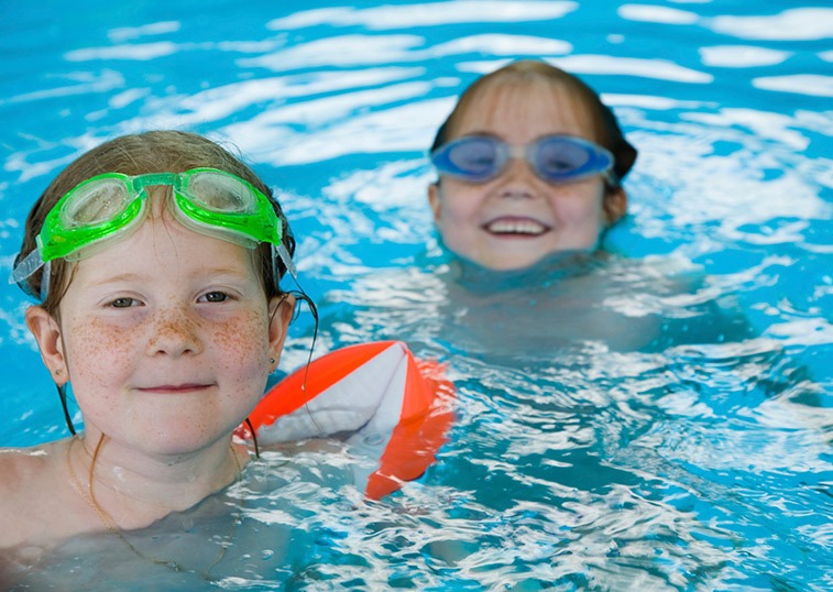 Little girls swimming in pool