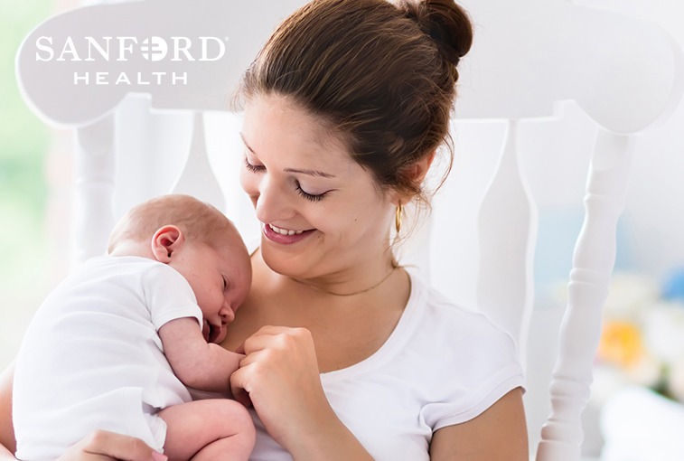 woman holding baby close and smiling