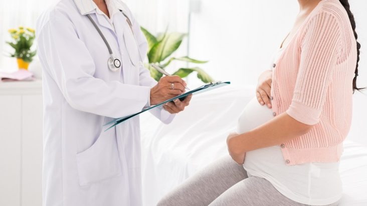 pregnant woman talking to a doctor