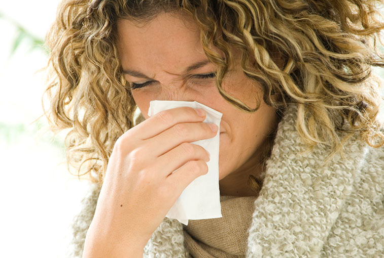 woman blowing nose