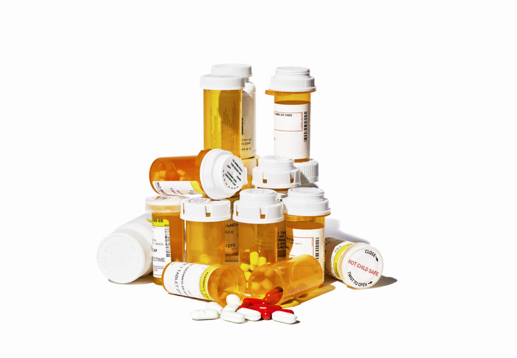Assorted Medication stacked on white background