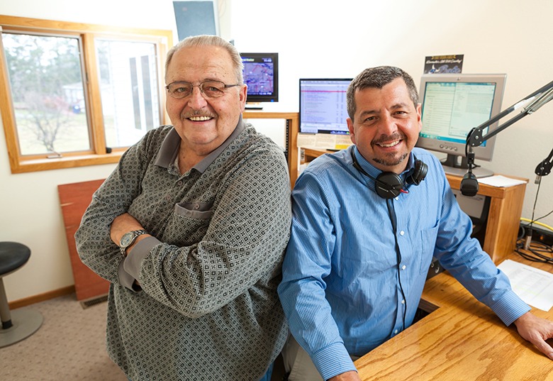 two guys in a studio smiling