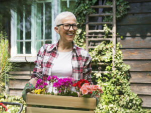 Mature person enjoys working at their garden.