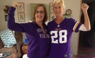 Two women flexing in Minnesota Vikings gear -- the power of mom and daughter colonoscopy.