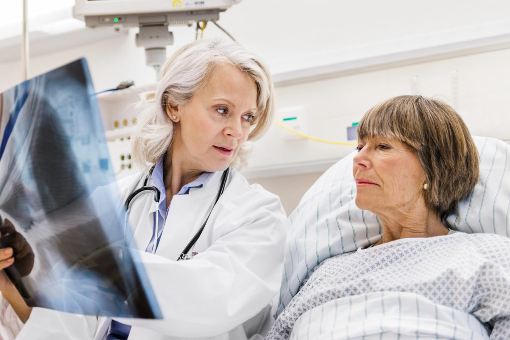 woman doctor showing female patient her x-rays.