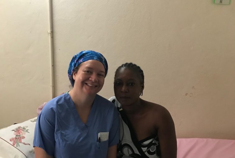 Billie with patient in Haiti during a medical mission.