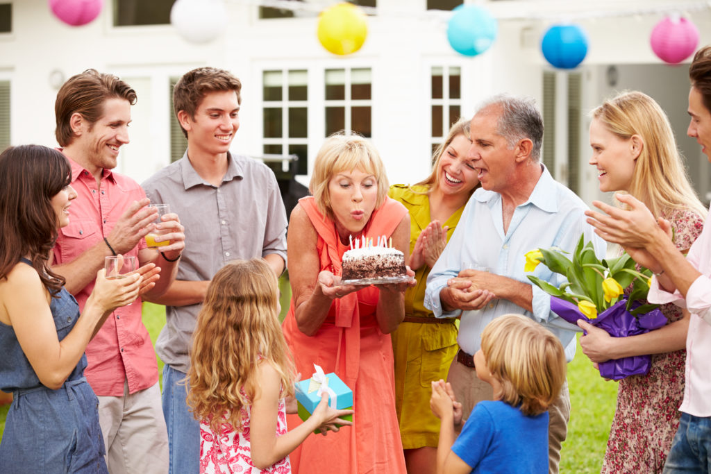 Multi Generation Family Celebrating Birthday In Garden