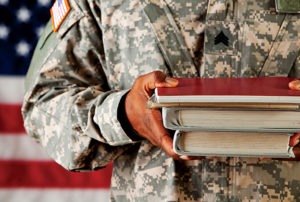 scholarship to veterans: army officer in uniform holding books