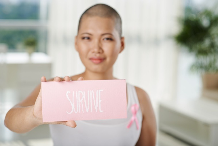 https://news.sanfordhealth.org/wp-content/uploads/2018/06/female-cancer-survivor-holding-sign.jpg