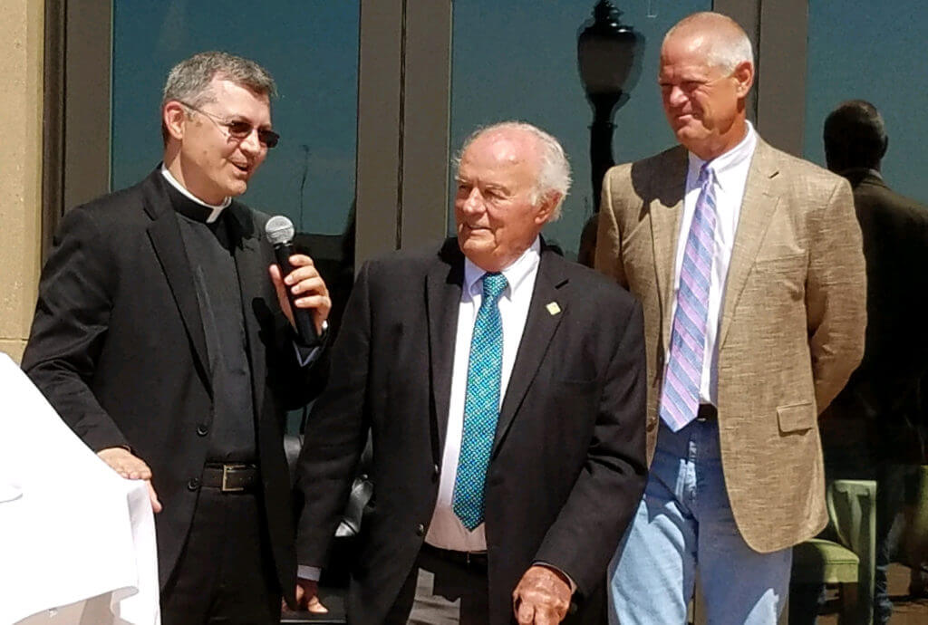 denny sanford, kelby krabbenhoft with a priest