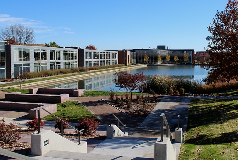 building with pond and fall trees