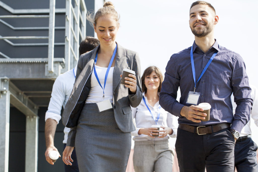 young professionals walking with coffee