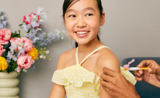 Young Asian girl receives back-to-school immunization