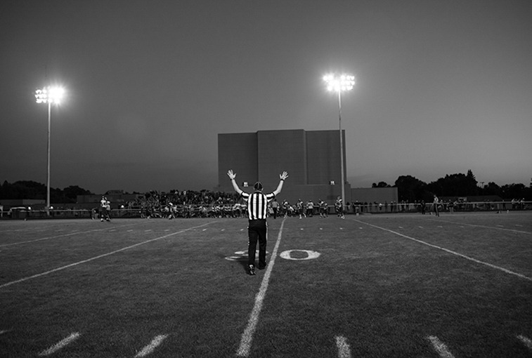A ref stops play action after a down on Sept. 7.