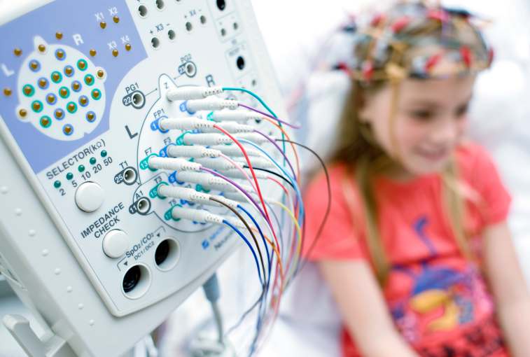 girl receiving electroencephalography for autism and adhd