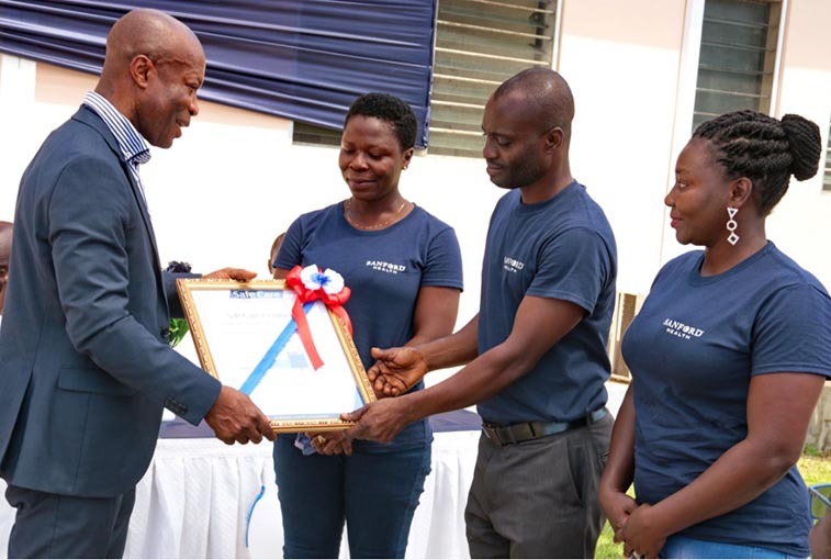 SLIDE SHOW: Dr. Kwasi Boahene of PAI presents a SafeCare certificate to Sanford Health employees Thywill Degbley, Alexander Yeboah and Patricia Ofosu in Kasoa, Ghana.