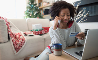 holiday stress: woman shopping online in Christmas living room