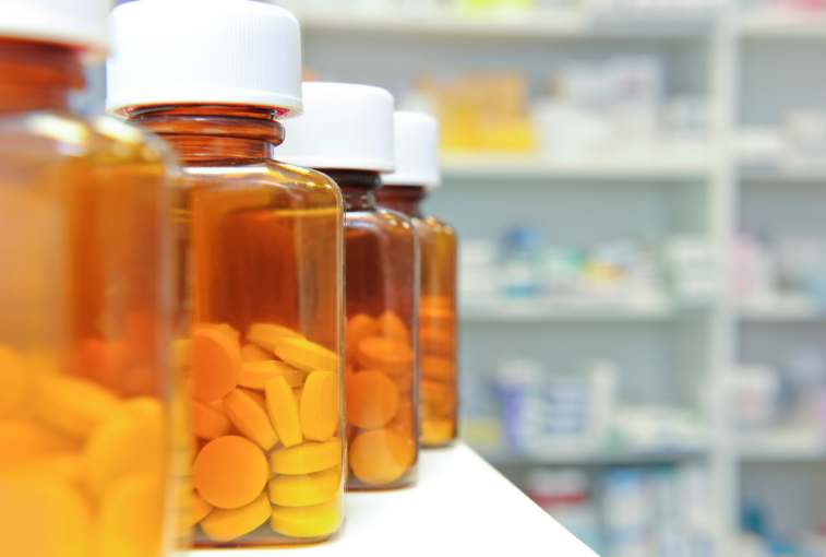meth drug addiction: row of bottles and pills on a chemists counter