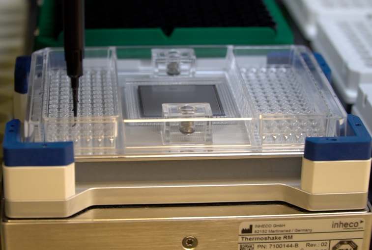One of the first steps in testing DNA for drug reactions involves a robot loading chemicals that will look for certain parts of the person's DNA in a tray on the left and the actual DNA in the right tray.
