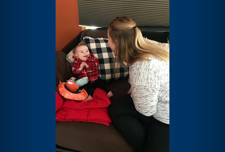 Good Samaritan Society home health nurse LaToya Buzalsky talks to baby Murphy in his home. (Photos by Sanford Health.)