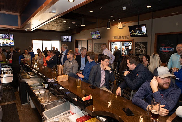 A crowd gathered at Blue Rock Bar and Grill on March 21 for the ribbon cutting of the newly opened restaurant at the Sanford Sports Complex.
