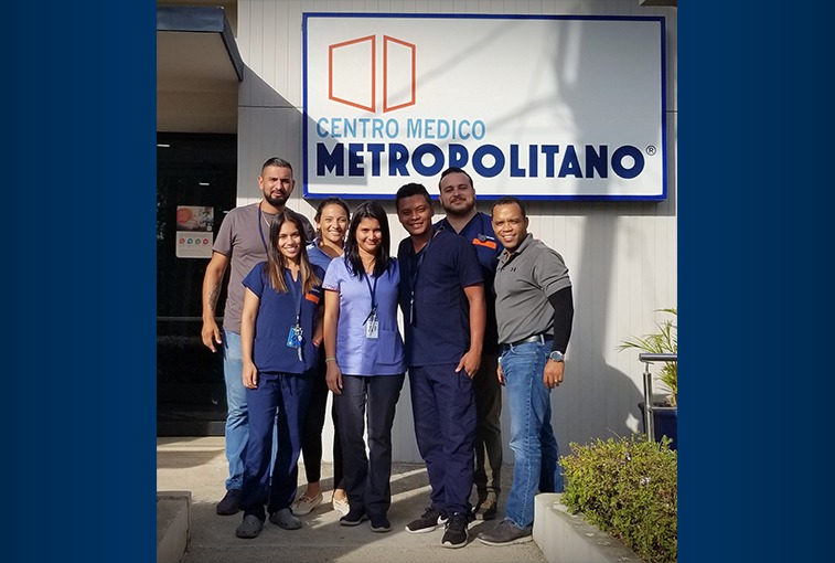 Jose Vasquez: A group of Sanford World Clinics health care providers stand in front of a sign that says "Centro Medico Metropolitano."
