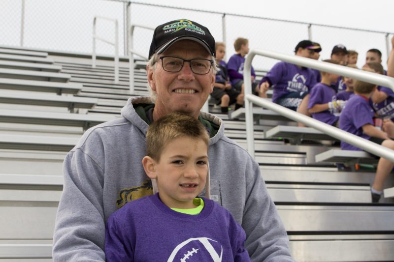 Al Schroeder waits with his grandson Nixon Huot before the arrival of Adam Thielen.