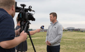 Micah Aberson speaks to a television news crew at the Sanford Sports Complex