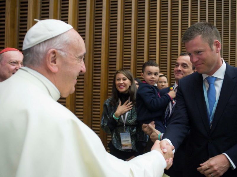 Pope Francis and Micah Aberson of Sanford Health shake hands.