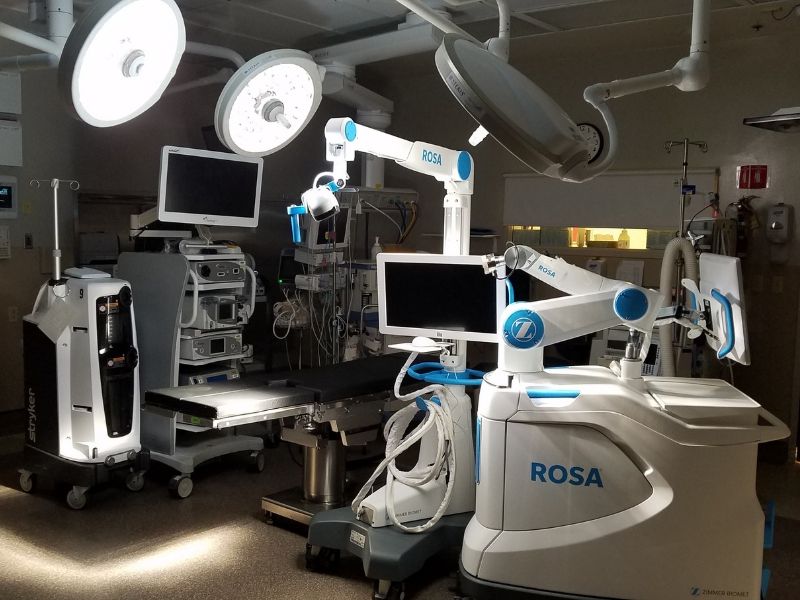 ROSA robotic-assisted surgery technology in an operating room.