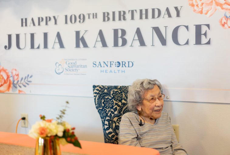 Julia Kabance sits under a banner reading "Happy 109th birthday Julia Kabance." She celebrated her 109th birthday at her home at Good Samaritan - Valley Vista in Kansas.