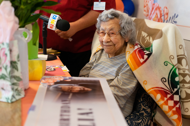 Julia Kabance smiles at her guests, gifts and cards recognizing her 109th birthday.