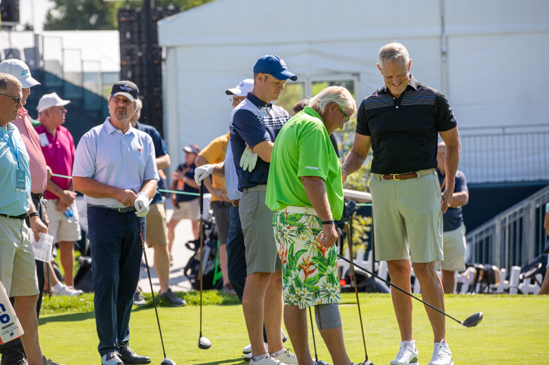 PGA Tour Champions golfer John Daly (center) chats with Sanford Health president and CEO Kelby Krabbenhoft (right) and vice president Micah Aberson during the pro-am tournament Wednesday at Minnehaha Country Club.