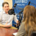 pediatric cancer research: Sam Milanovich having a conversation with Jacqueline Palfy in front of microphones