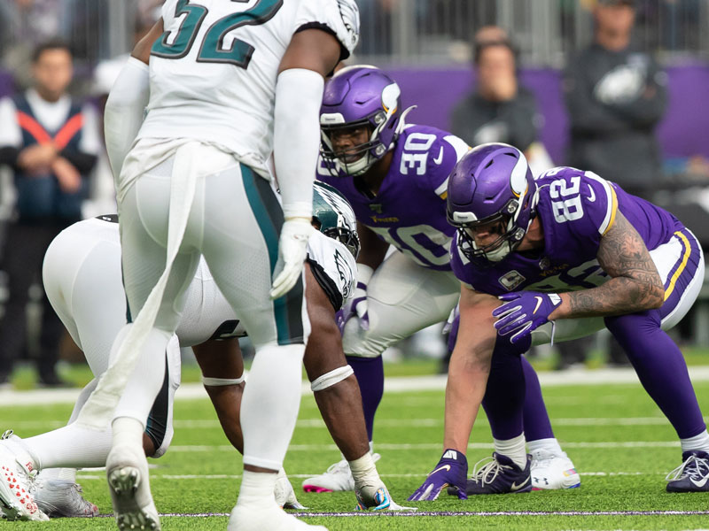 Vikings players C.J. Ham (30) and Kyle Rudolph (82) take on the Eagles at the line of scrimmage during their Oct. 13 game. (Photo by Lisa Johansen Aust, Sanford Health)