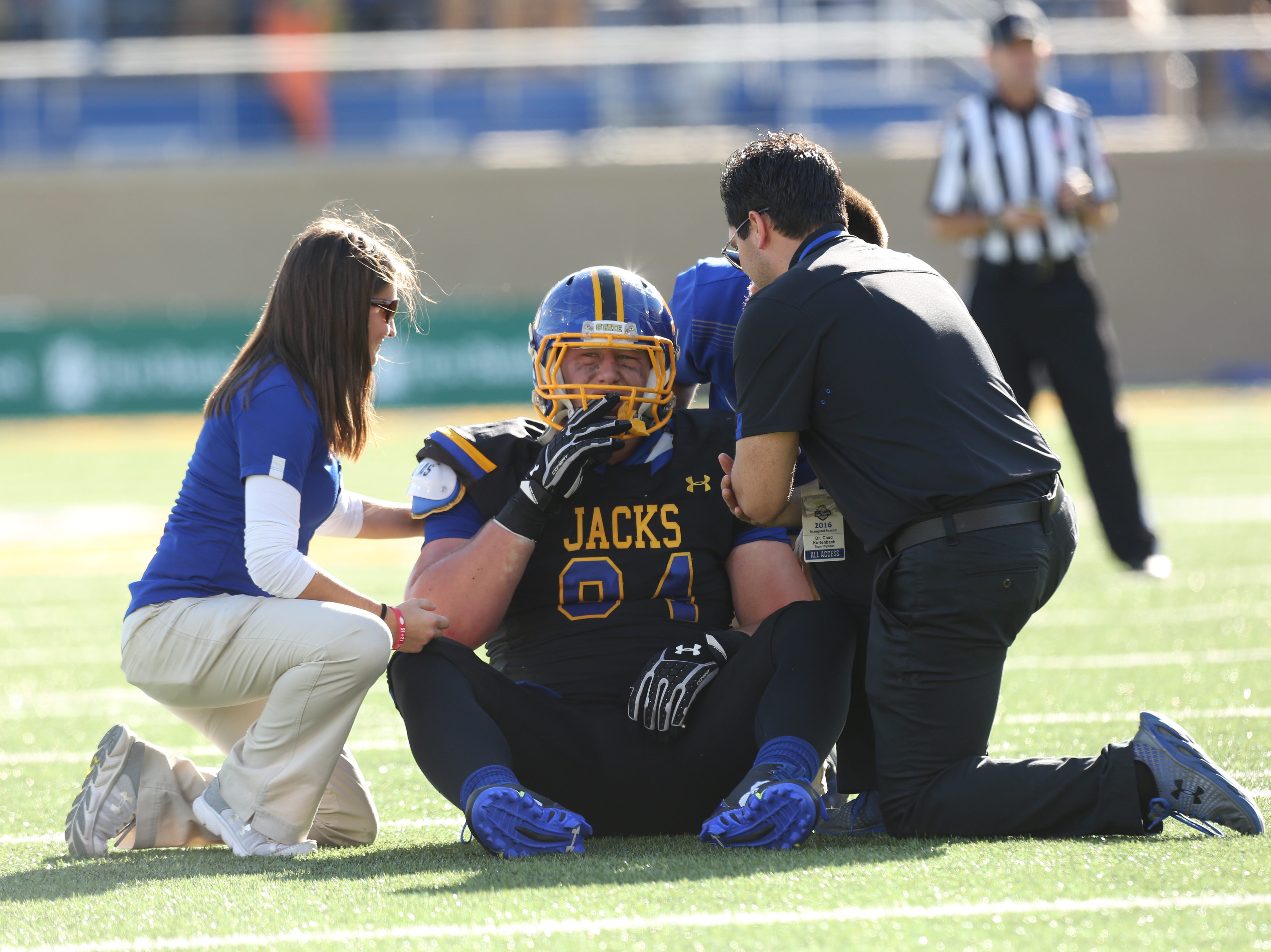 Sanford Health's Dr. Chad Kurtenbach tends to an injured South Dakota State football player. (Photo by Sanford Health)