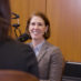 Dr. Suttle smiling facing a host and a microphone.