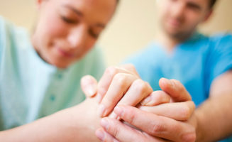 Miscarriage: young woman and man holding hands, grieving loss of baby