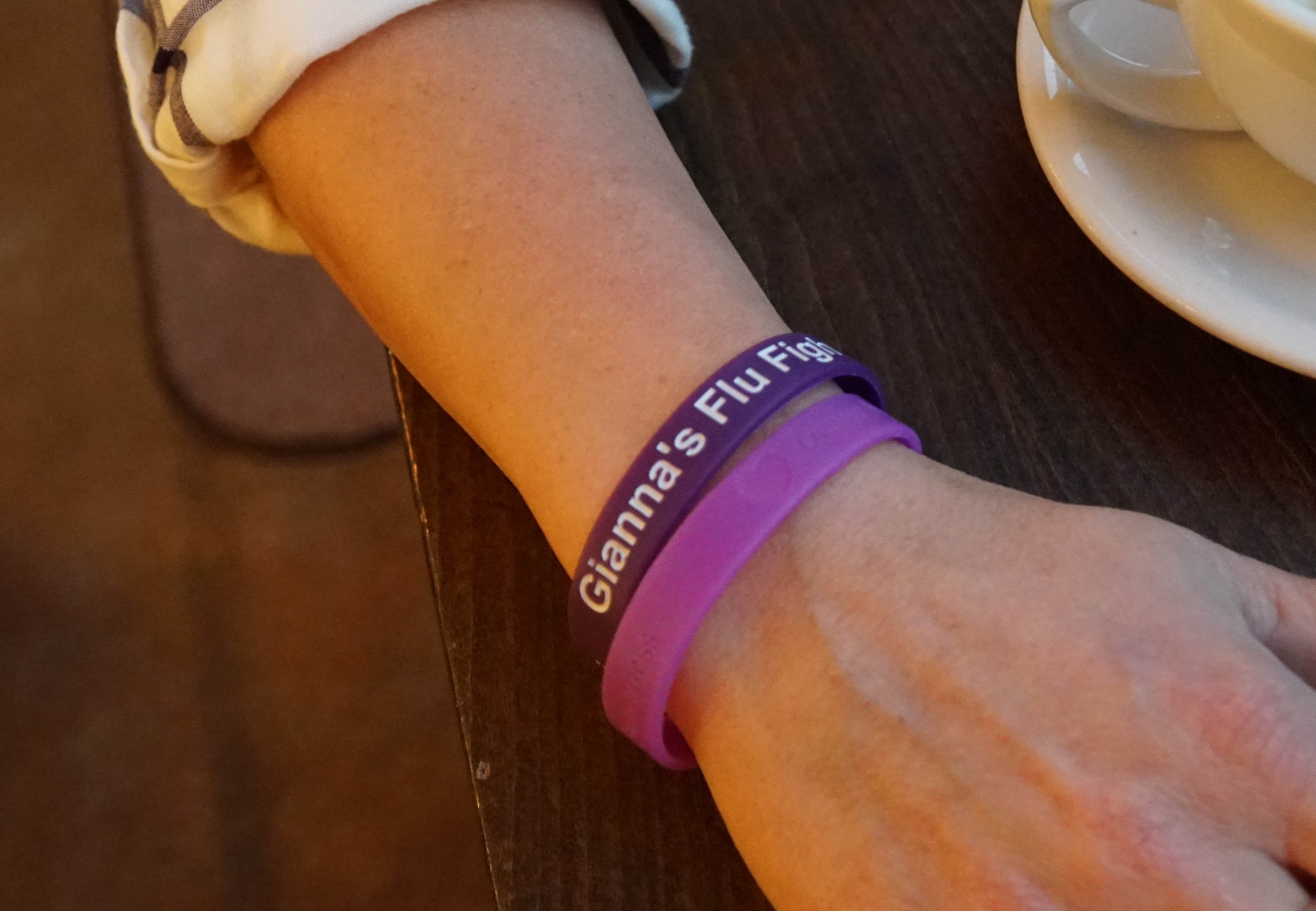 Flu shot advocate Angie Wehrkamp wears bracelets on her wrist in honor of her daughter, Gianna.