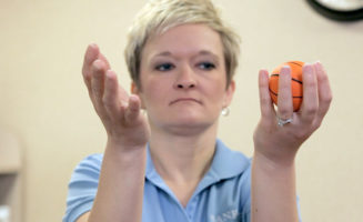 dizziness vertigo imbalance exercises: woman using small ball to train eye movement
