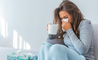 Cold And Flu. Portrait Of Ill Woman Caught Cold, Feeling Sick And Sneezing In Paper Wipe. Closeup Of Beautiful Unhealthy Girl Covered In Blanket Wiping Nose.