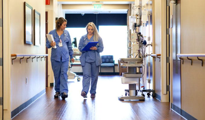 A healthy work environment fights doctor burnout. Clinicians walk down an Aberdeen medical center hallway.