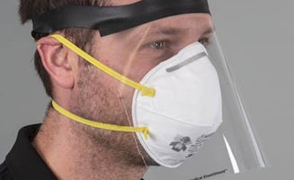 A man wears a face shield, one of many shields that a Worthington, Minn., company plans to make.