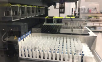 Hundreds of test tubes hold COVID-19 tests underway at Sanford laboratory