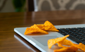Piles of chips sit on an open laptop near the keyboard.