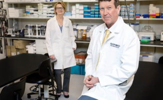 Sharon Hunt and David Pearce are shown in a Sanford Research lab