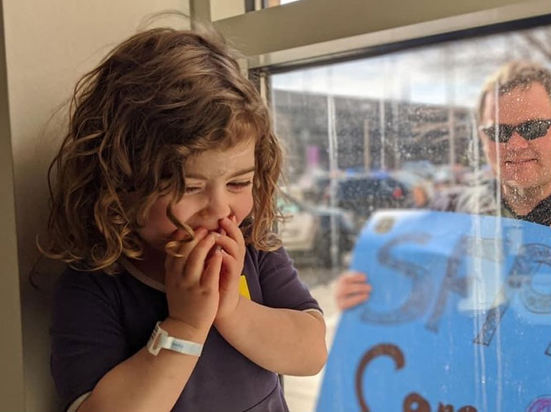 SLIDE SHOW (1/14): Sanford Children's Hospital patient Natalie Dose, 4, giggles as she gets a visit from a police officer at her window. (Photo courtesy of  Brianna Dose)