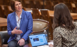 Allison Suttle faces Courtney Collen during an interview about health care
